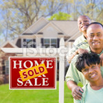 stock-photo-24014101-african-american-family-in-front-of-sold-sign-and-house